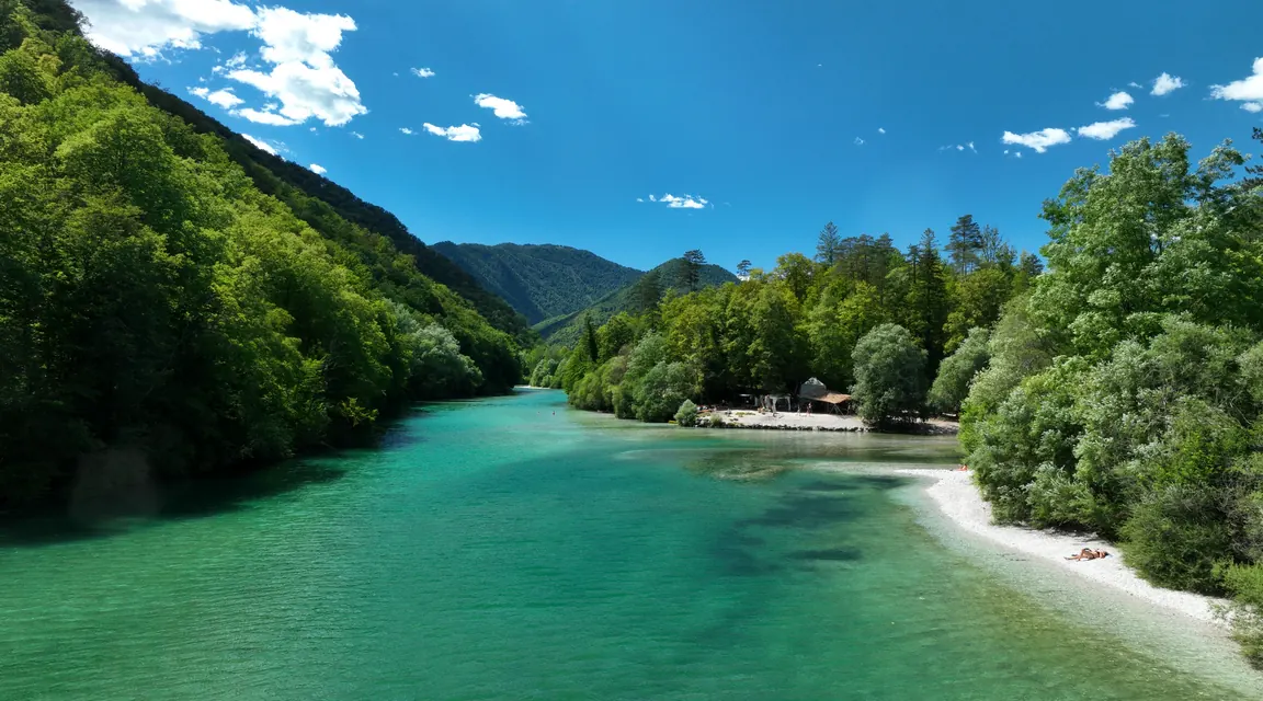 A turquoise river winding through forest