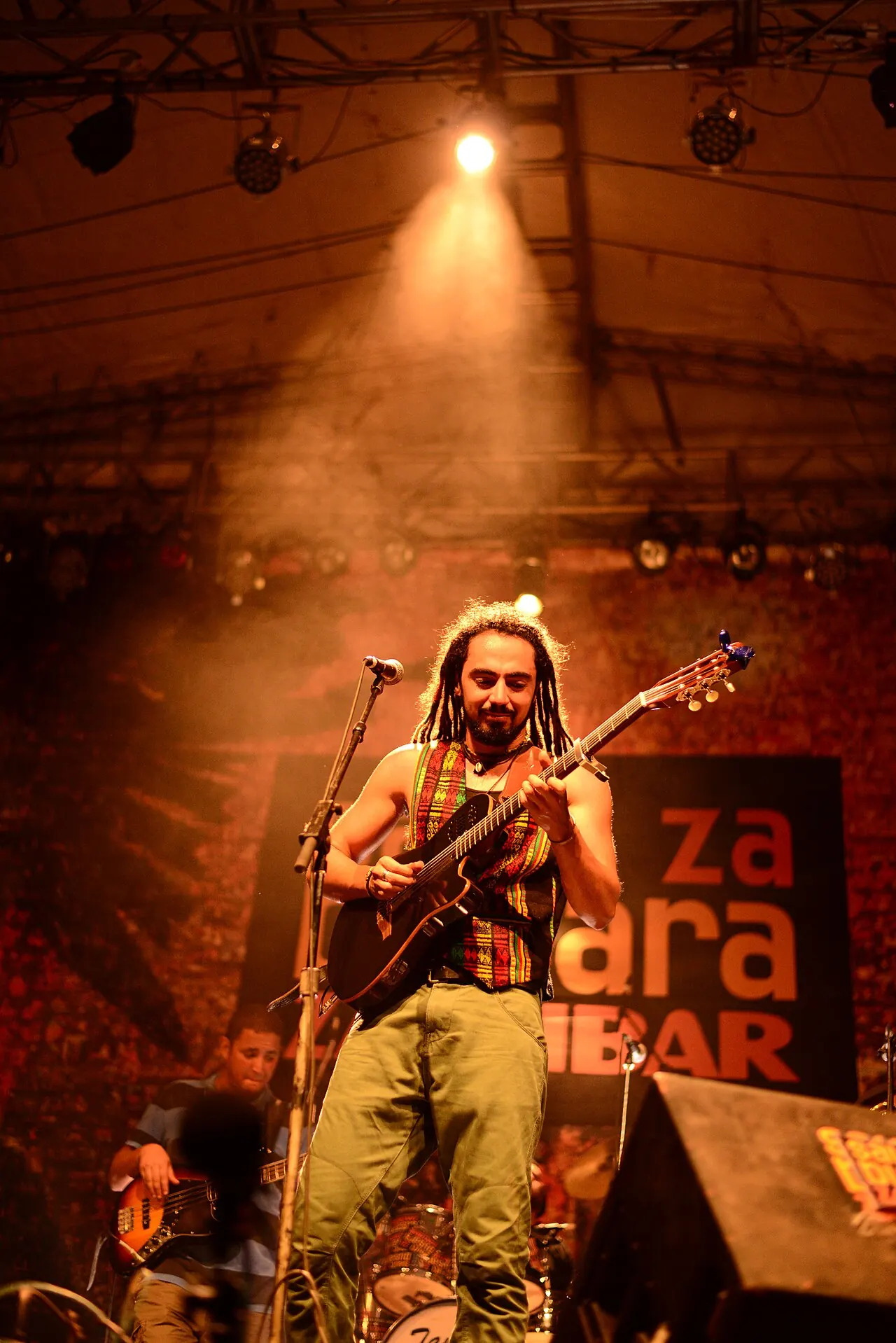 A musician performing on a lit stage