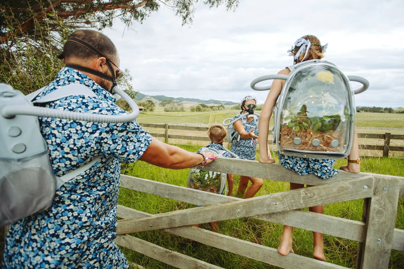 Two festival-goers with backpacks at a farm gate