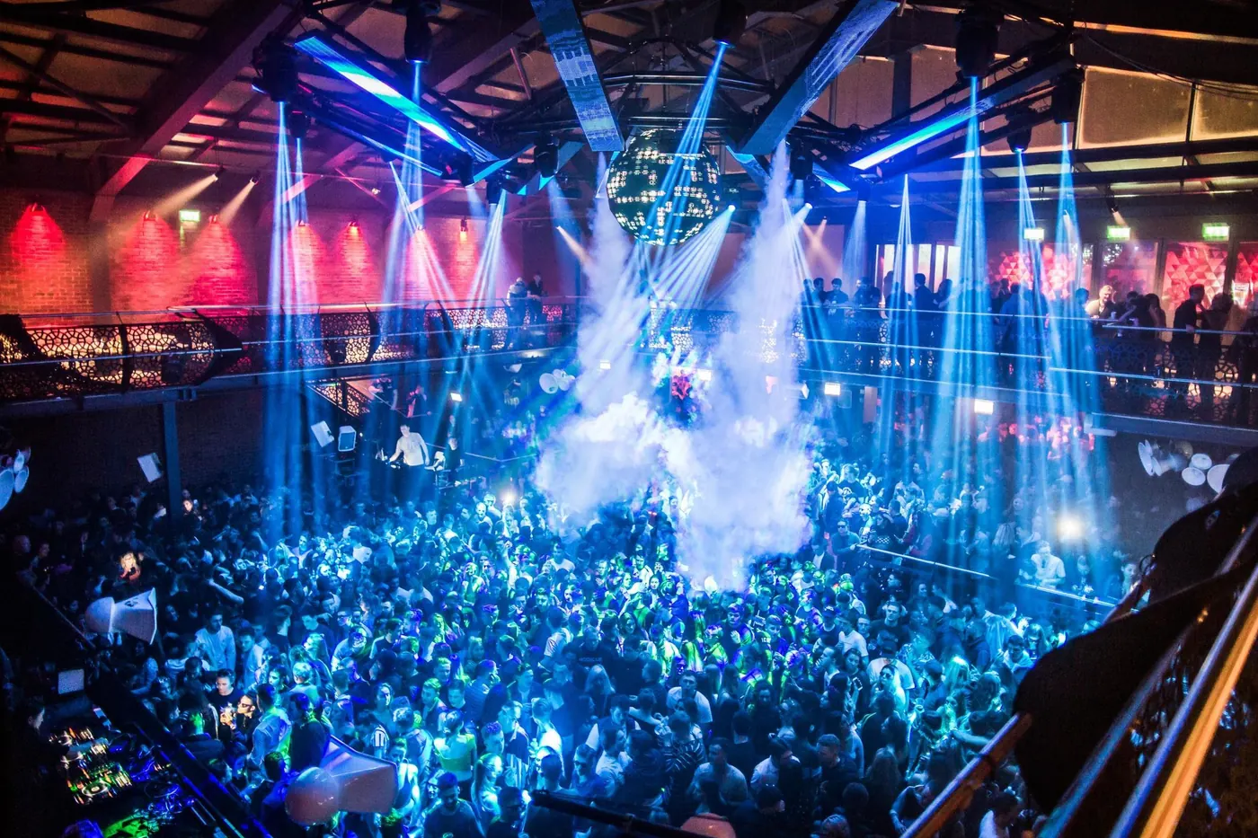 Blue lasers and smoke over a crowd at Studio 338