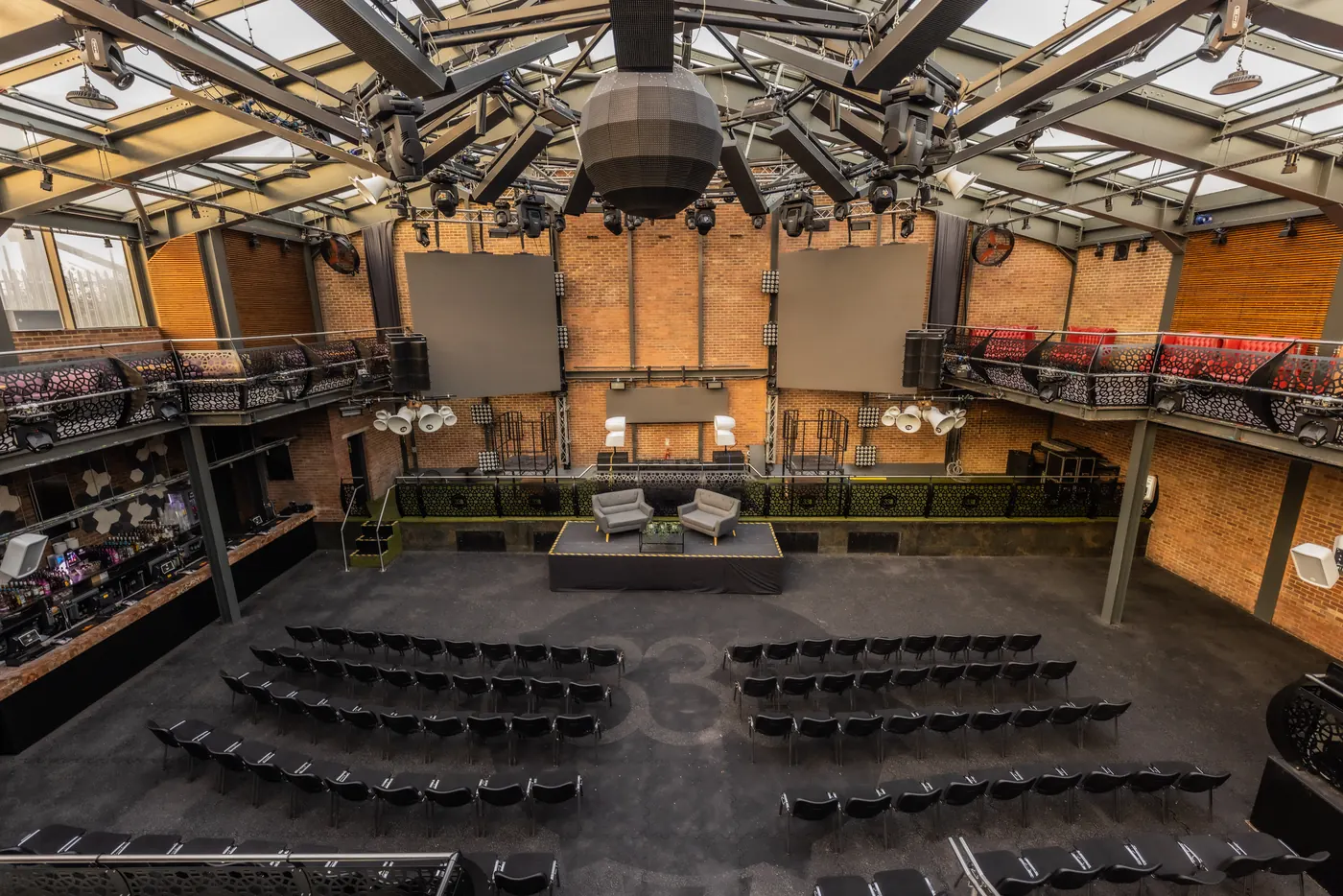 The Studio 338 hall set out with tables under a glass roof