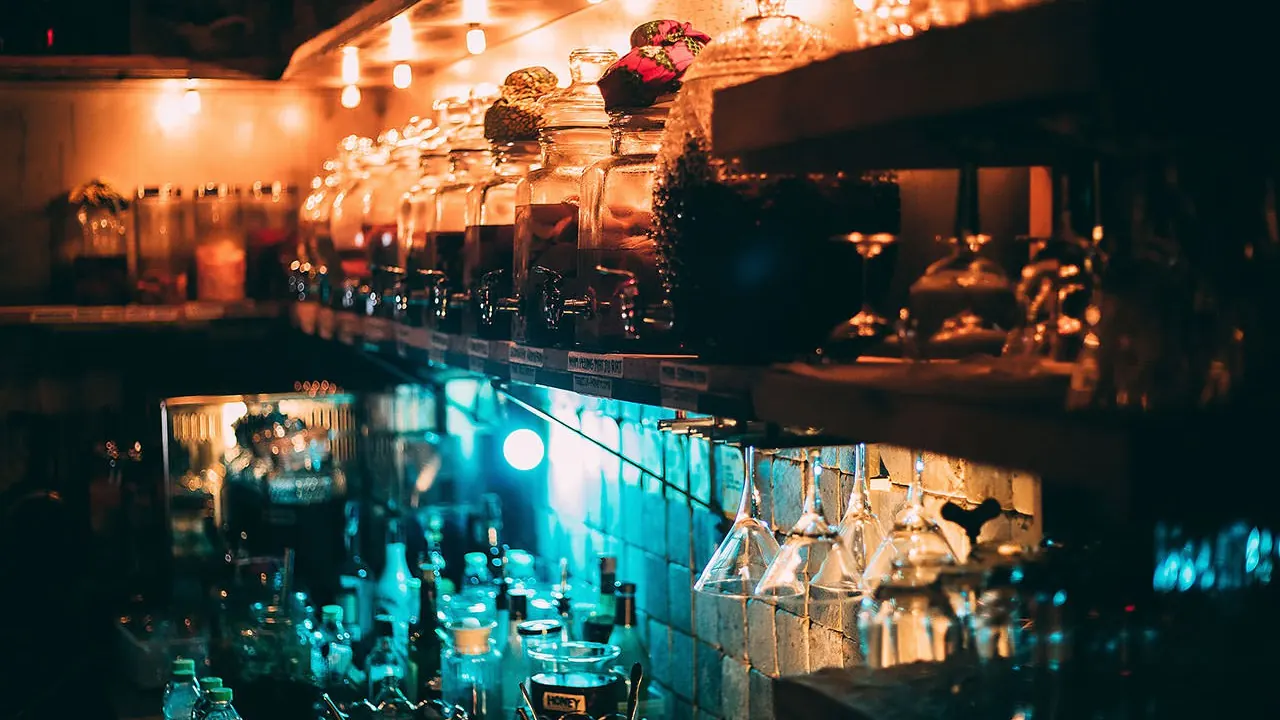 A neon-lit corner of the bar in teal light