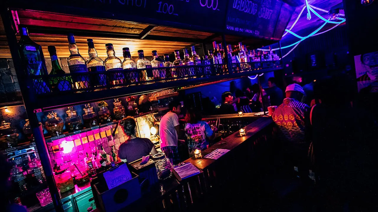 A pink-and-blue lit bar counter
