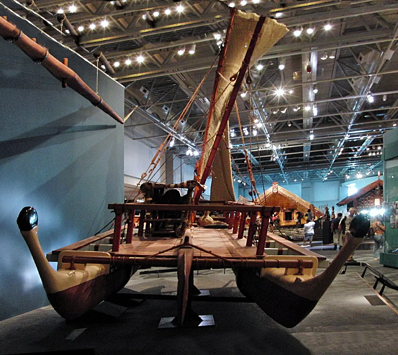 A carved waka in a museum hall