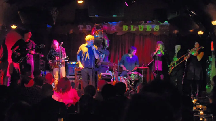 A band performing under coloured lights
