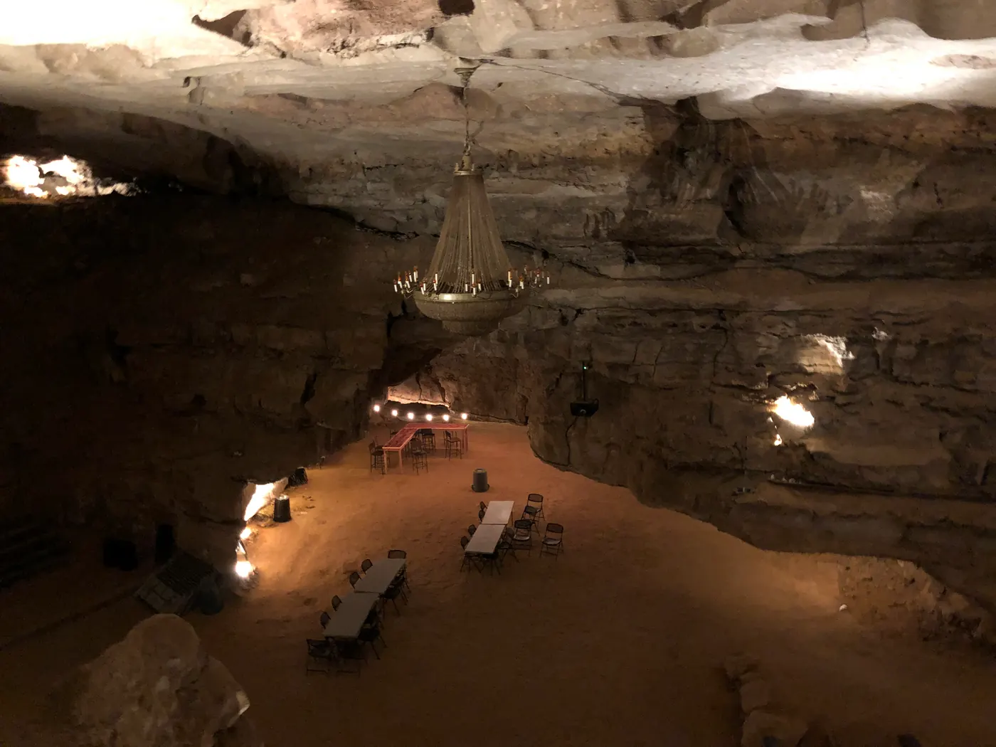 A wide cave passage with a lit path