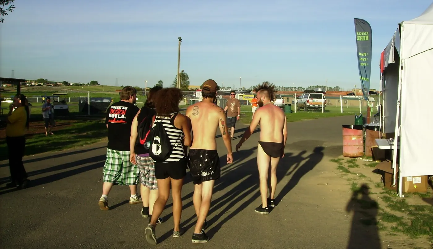 Festival-goers walking along a track beside the campground at the Gorge