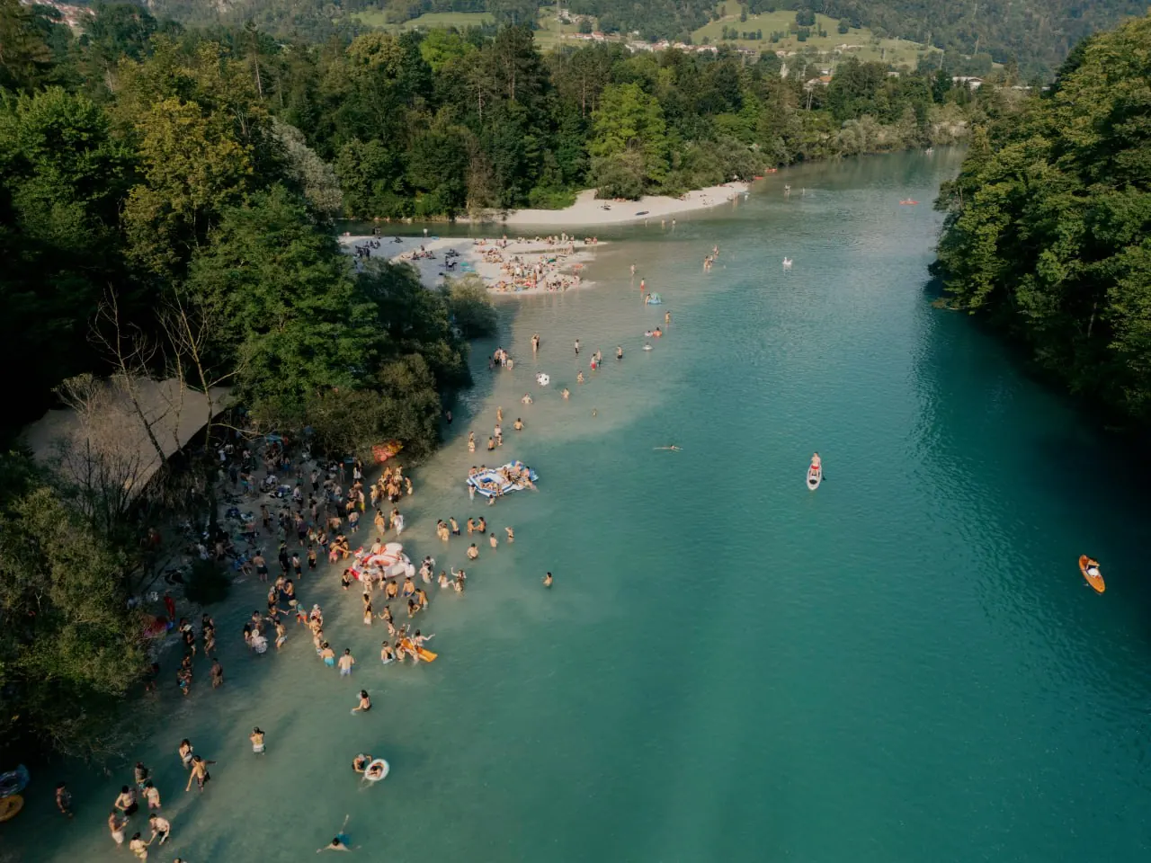 The turquoise Soča river winding through a green gorge, seen from above