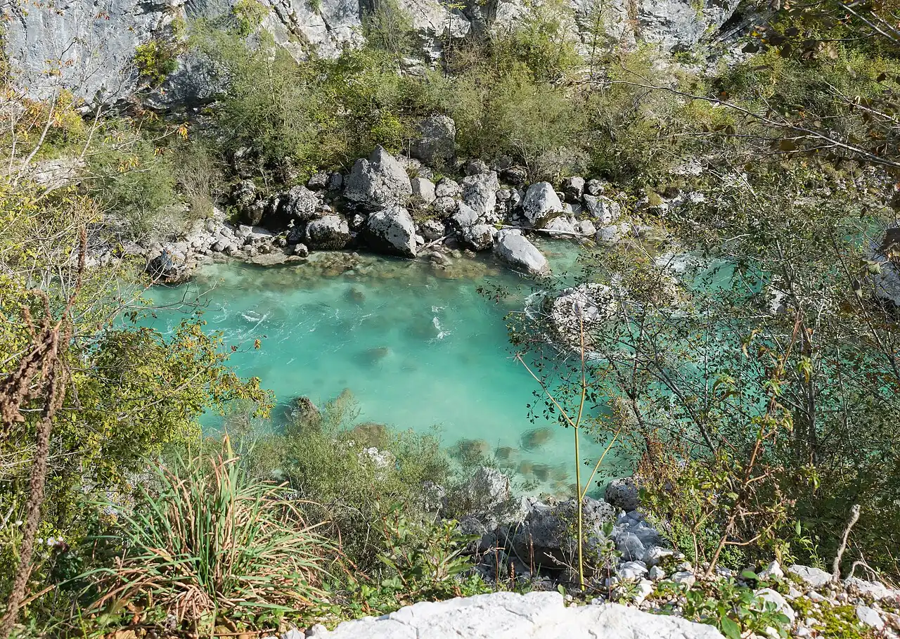 A clear turquoise pool in the rocky river