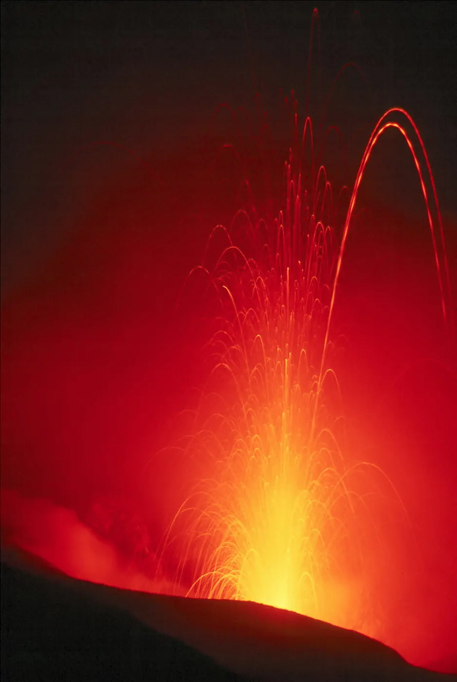 A red arc of lava thrown from a vent