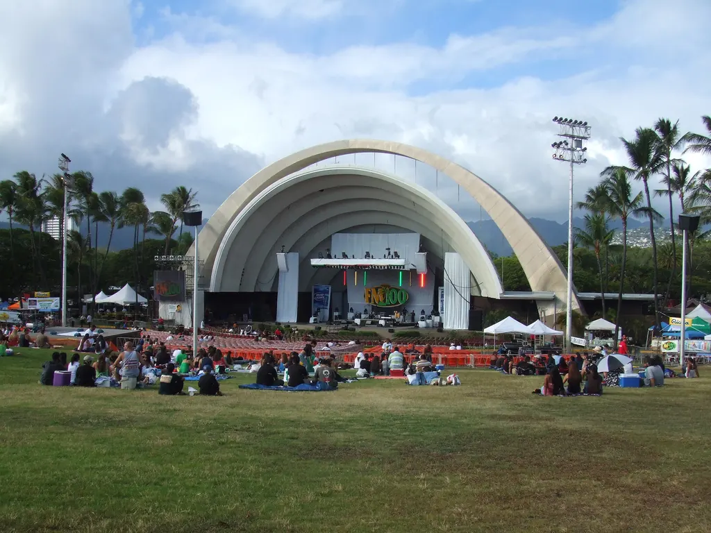 The Waikiki Shell bandshell with cars and a crowd in front