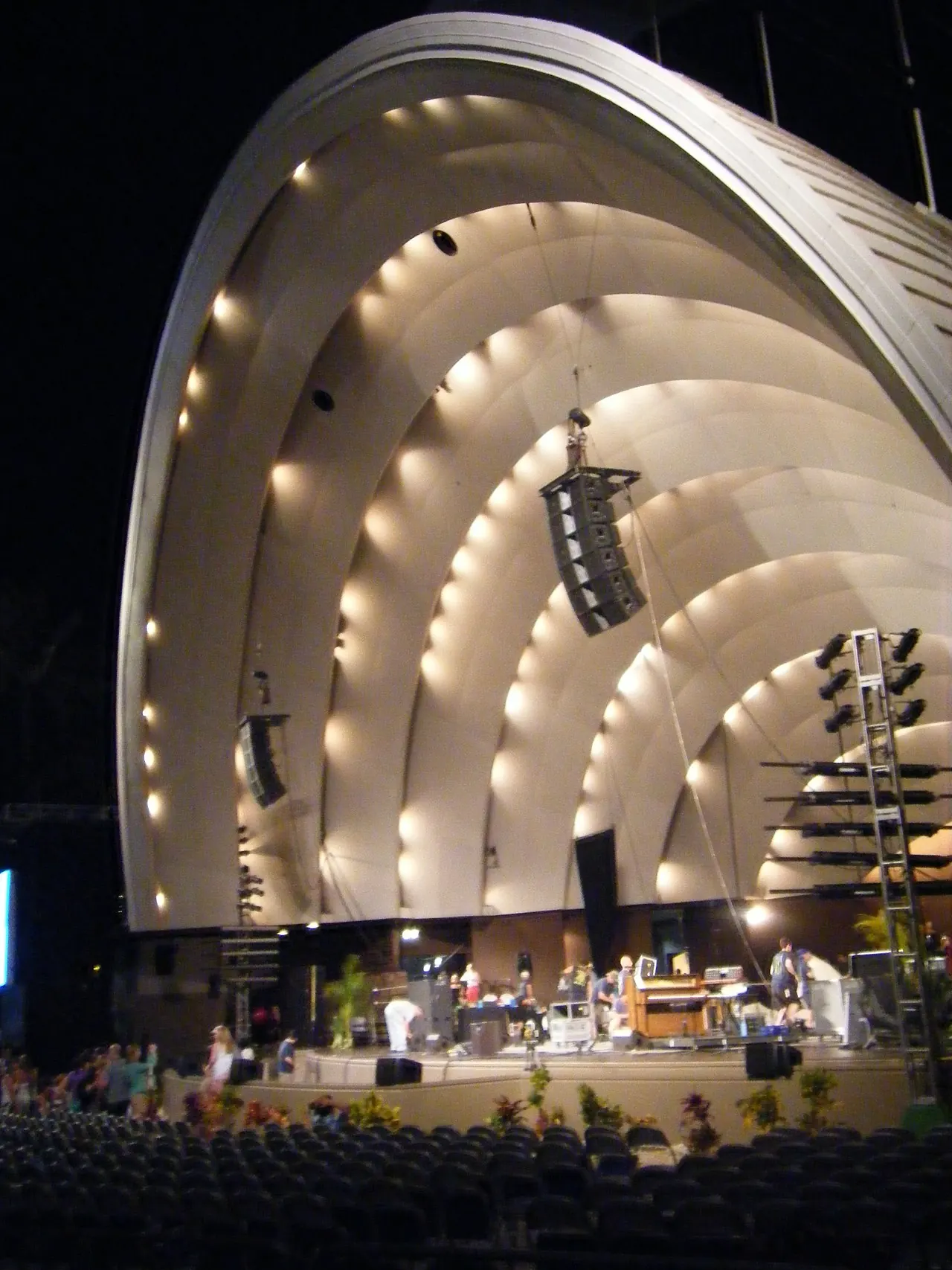 The shell's curved roof lit at night