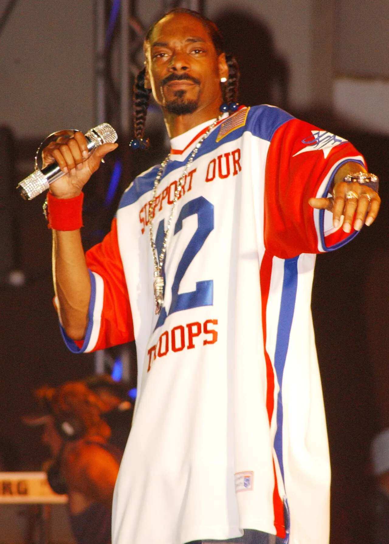 A performer in a jersey holding a microphone
