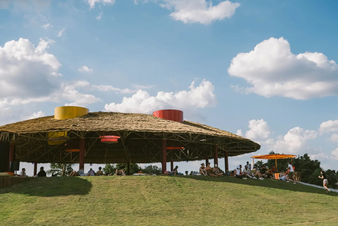A domed pavilion on a green lawn under a blue sky