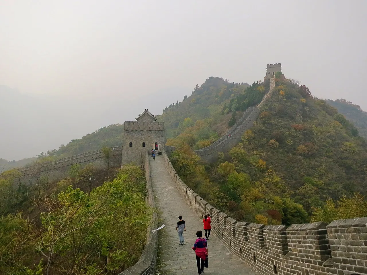 A section of the Great Wall winding over green hills