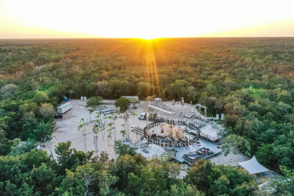 An aerial view of a jungle clearing at sunset