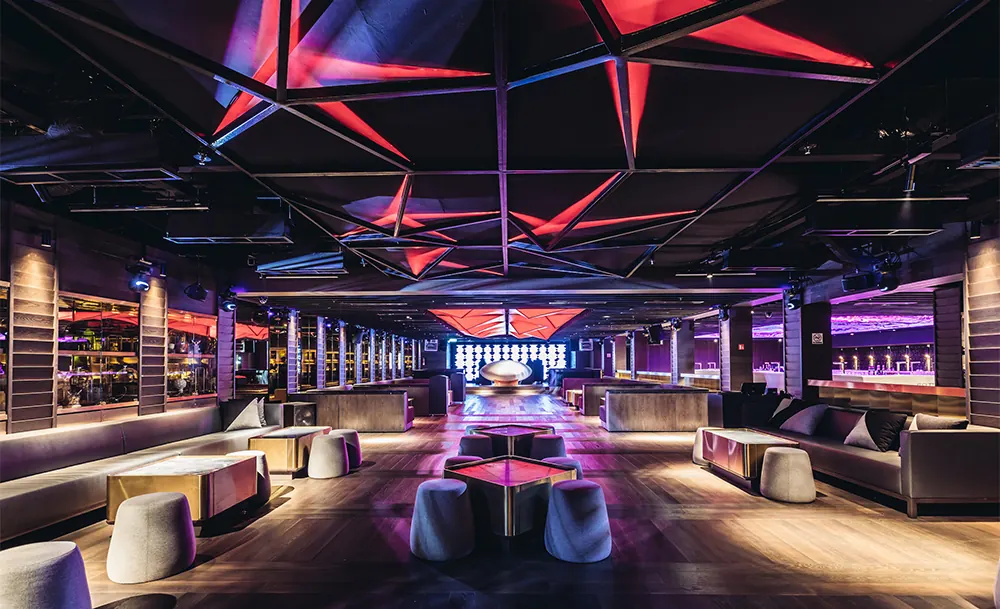 A large club hall with purple and red lighting