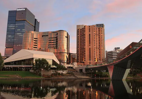 The Adelaide Festival Centre beside the river with city towers behind
