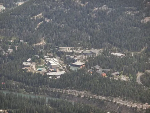 An aerial view of buildings scattered among forest on Tunnel Mountain