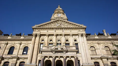 The Edwardian sandstone facade of Cape Town City Hall under a clear blue sky