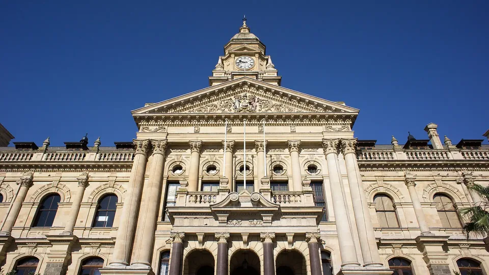 The Edwardian sandstone facade of Cape Town City Hall under a clear blue sky