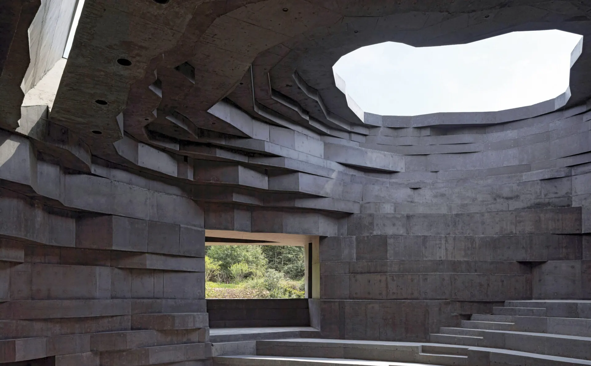 Inside the Chapel of Sound: a concrete bowl of stepped seating under a skylight