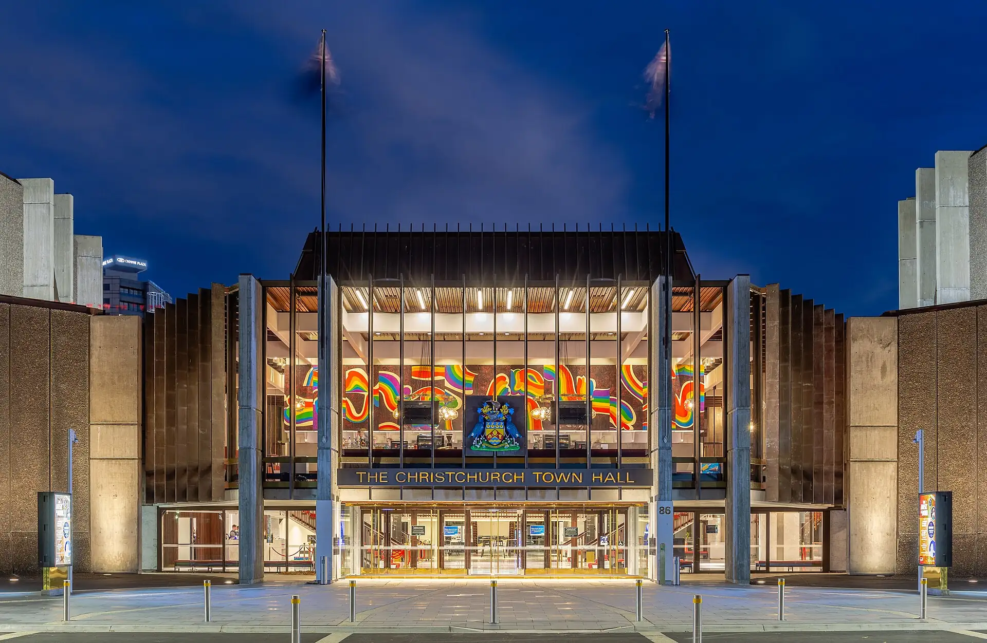 The glass-fronted entrance of Christchurch Town Hall lit at night