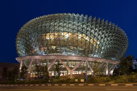 The spiky glass domes of the Esplanade lit blue at dusk