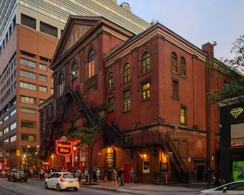 The red-brick facade of Massey Hall in Toronto in evening light