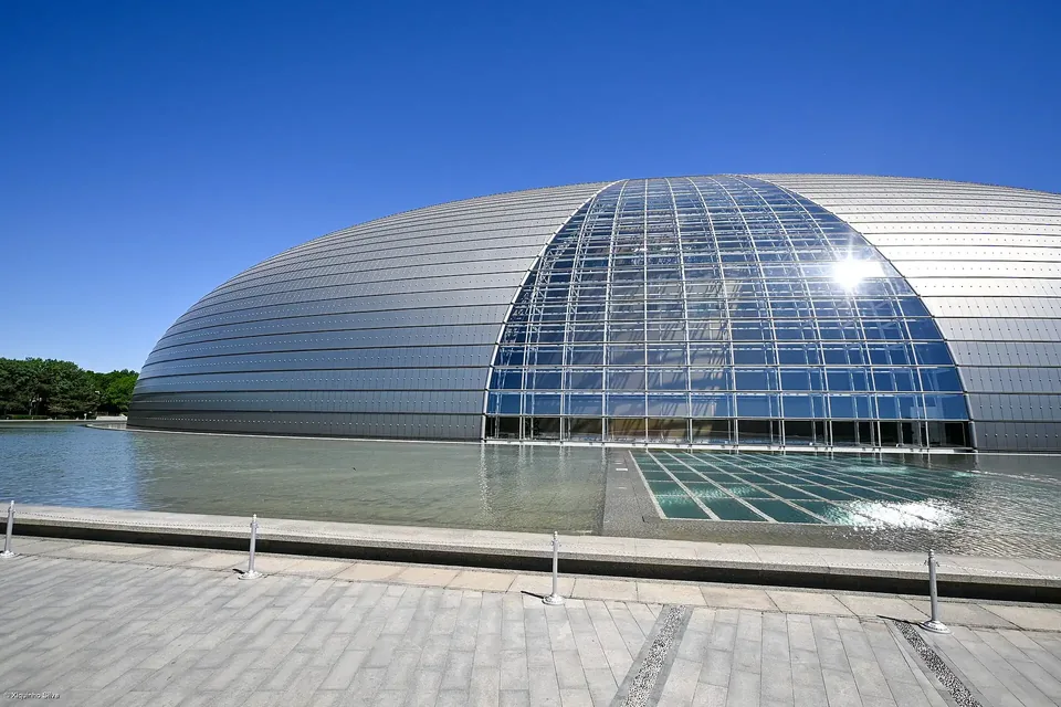 The National Centre for the Performing Arts, a glass and titanium dome beside a lake