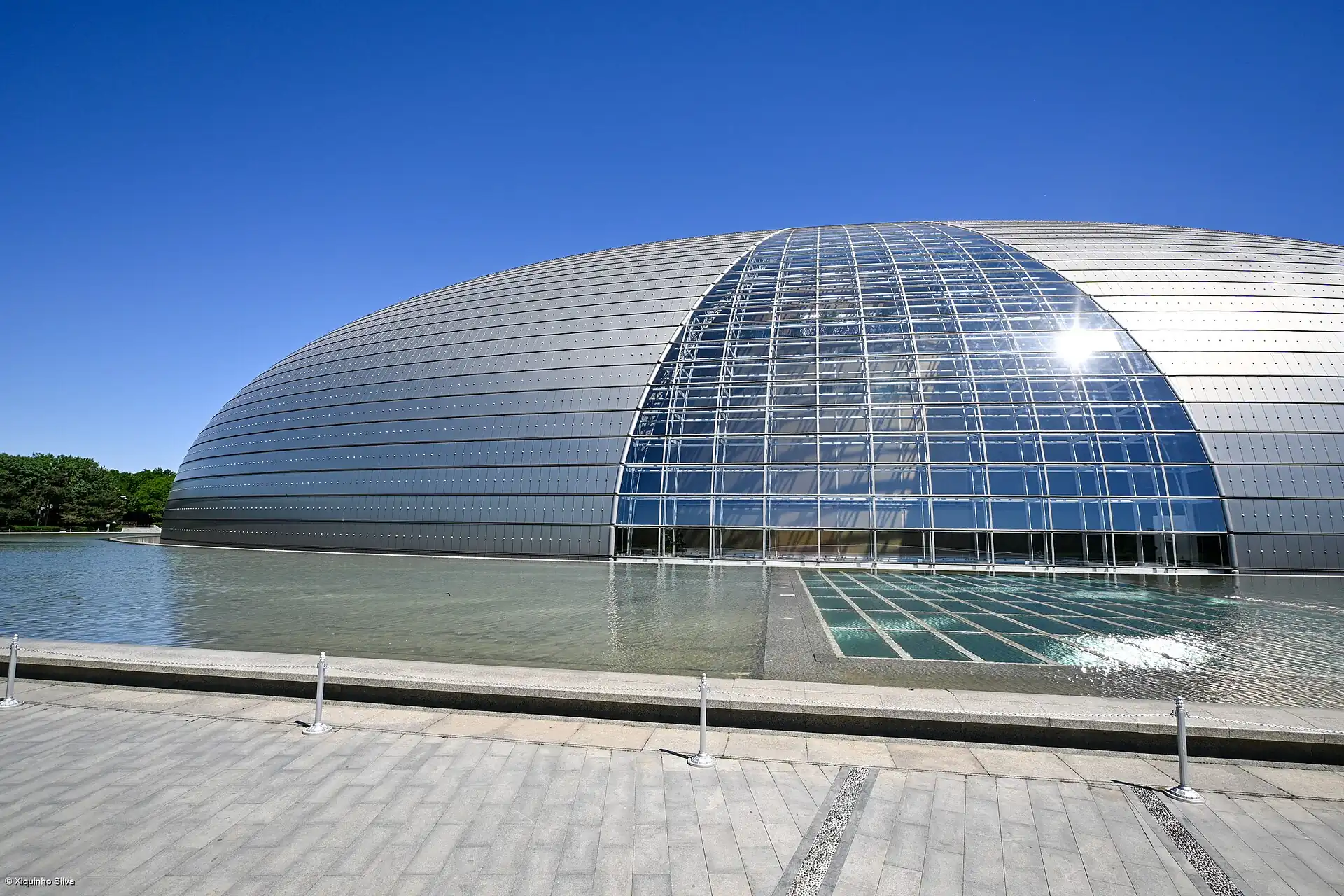 The National Centre for the Performing Arts, a glass and titanium dome beside a lake