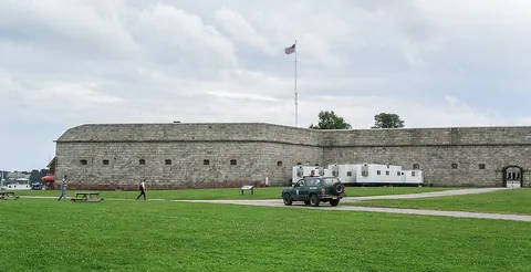 The grassy grounds and stone walls of Fort Adams in Newport