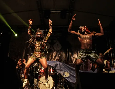 Gato Preto on stage at Nyege Nyege in Jinja, two performers mid-dance under a green laser