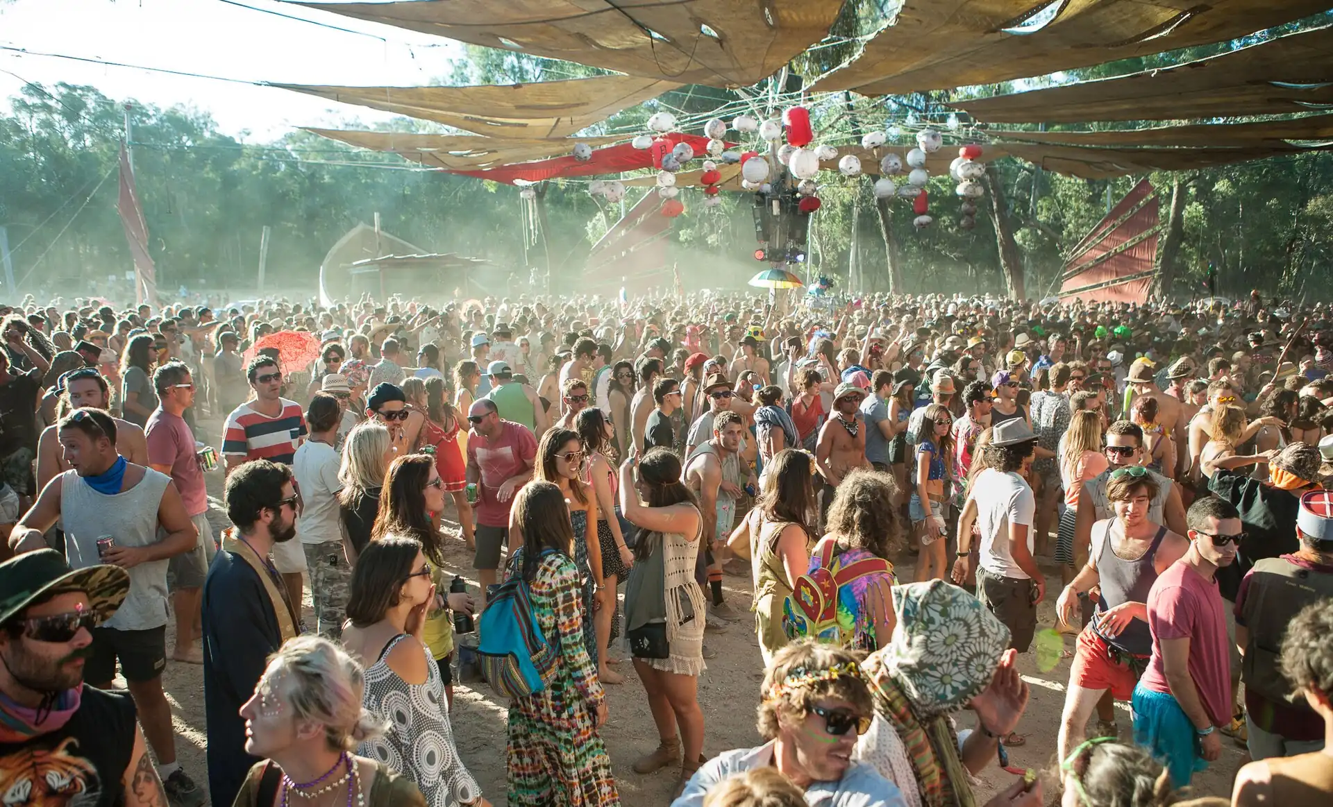 A huge crowd dancing under shade sails at Rainbow Spirit