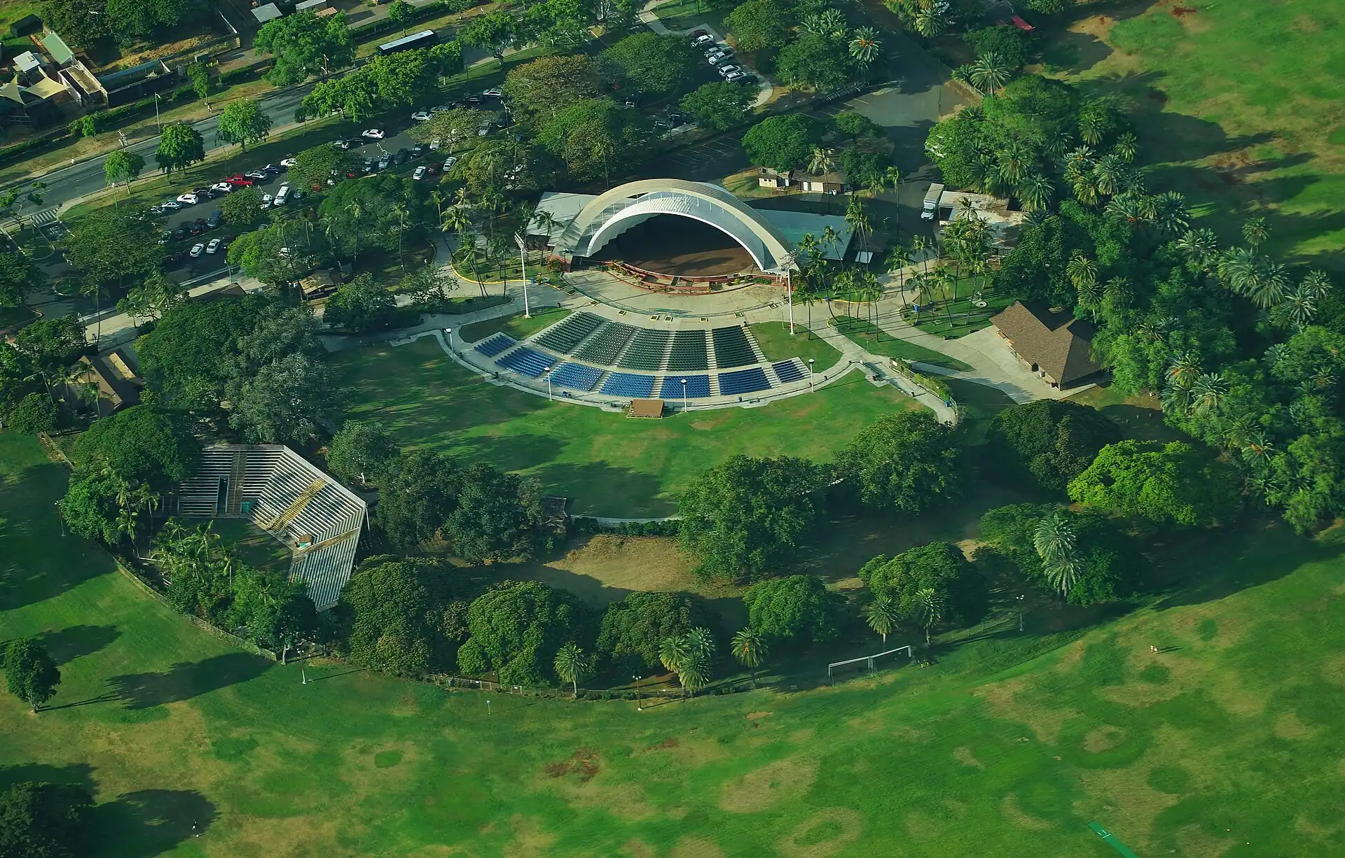 An aerial view of the Waikiki Shell in a green park
