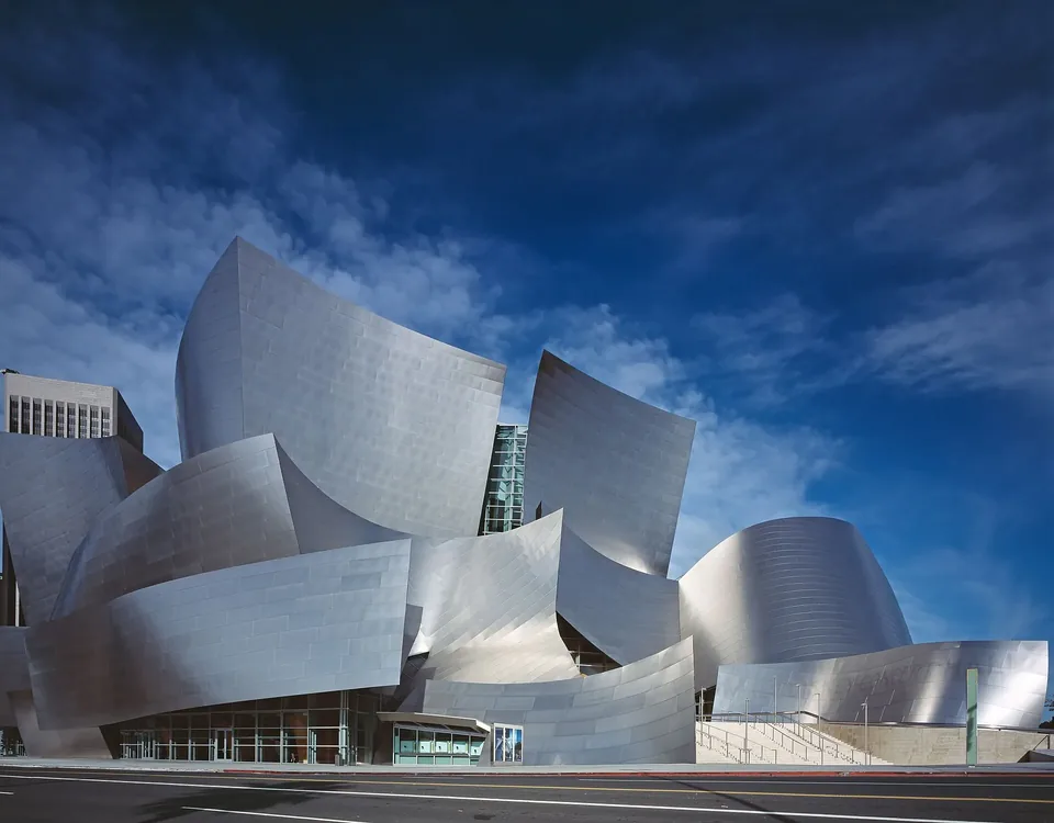 The stainless steel curves of Walt Disney Concert Hall against a blue sky