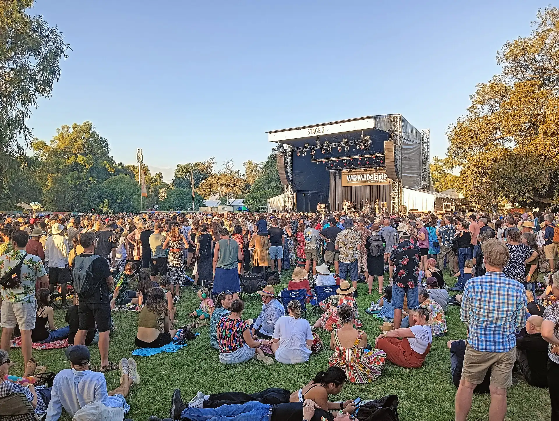 A crowd on the grass in front of a park stage at WOMADelaide