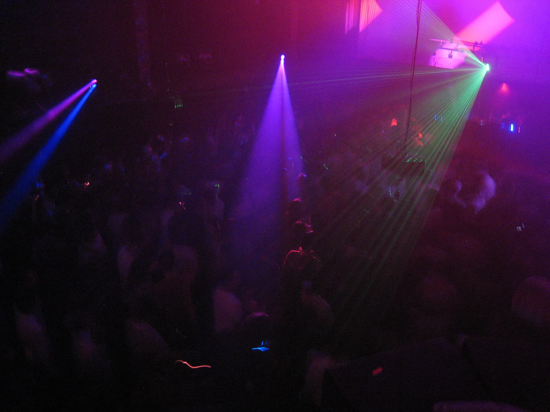 Purple and magenta lasers over a dark dancefloor at Womb