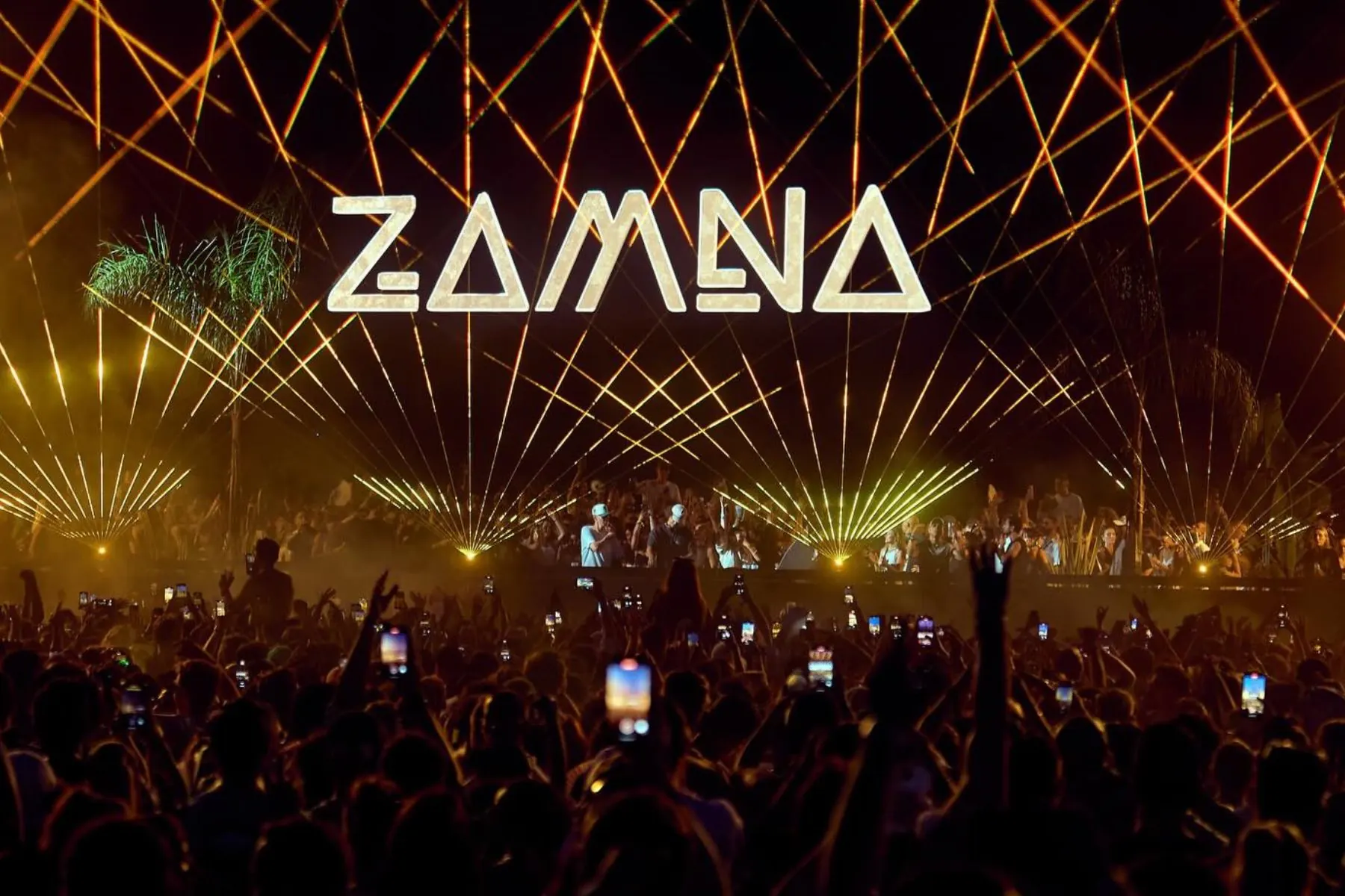 The Zamna sign above a crowd at night
