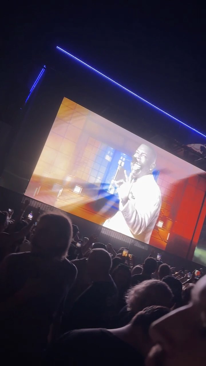 Jacob Lusk in a white suit on the big screens during Natural Blues