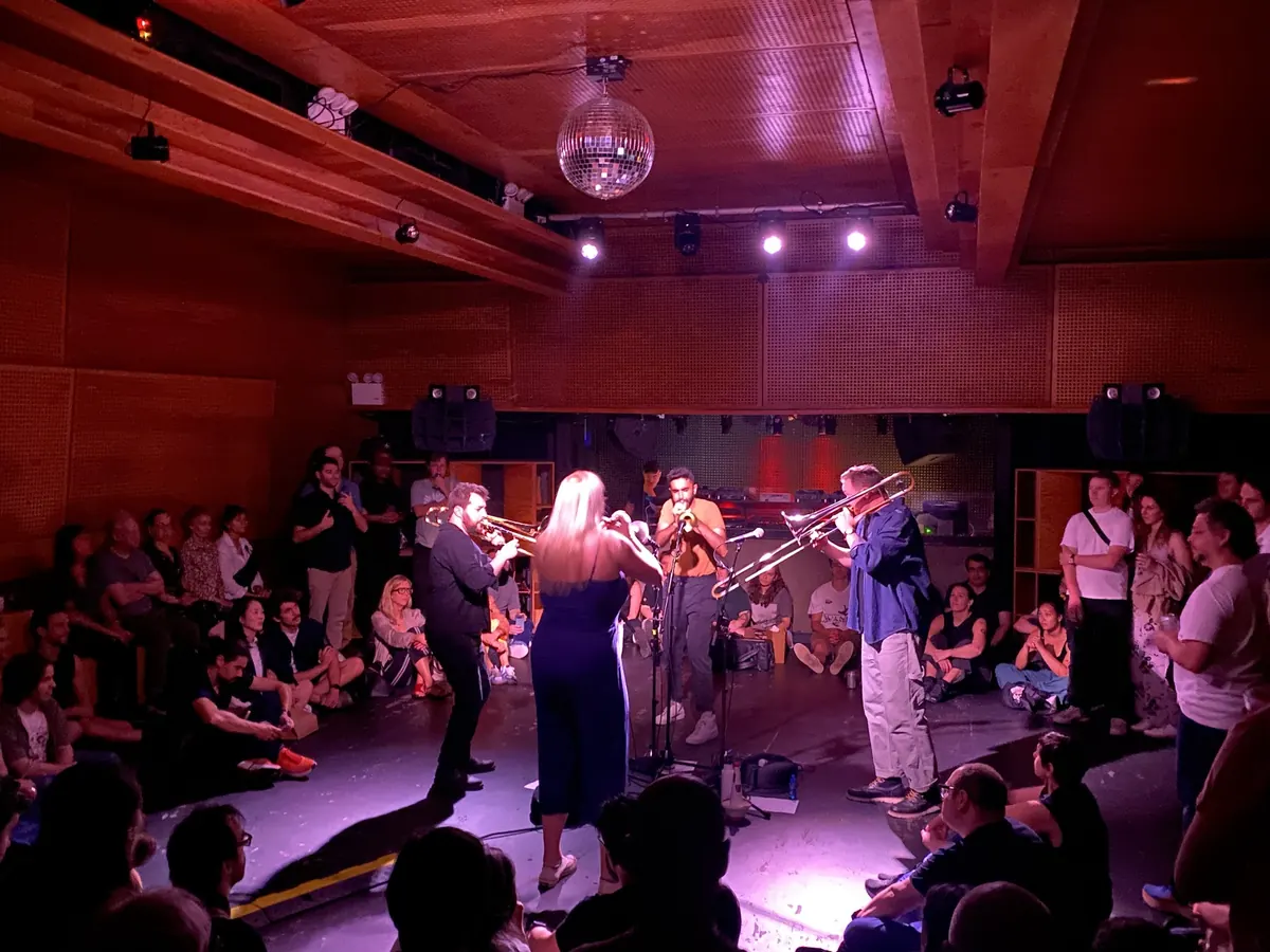 The Westerlies, a brass quartet, playing to a seated crowd in the wood-panelled Sound Room at Public Records, Brooklyn